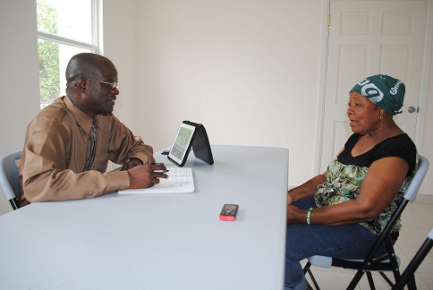 St. Kitts- Nevis Attorney General, Hon. Patrice Nisbett speaking with St. James Parish resident, Ms. Govania Butler